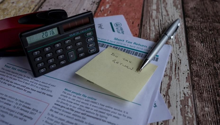document on a table with a note and calculator fishers in