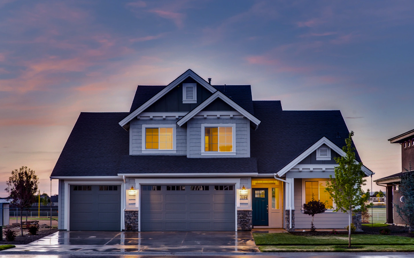 white modern house with blue roofing in a residential area fishers in
